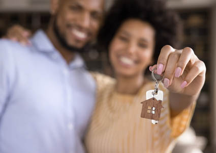 couple holding keys to their new home